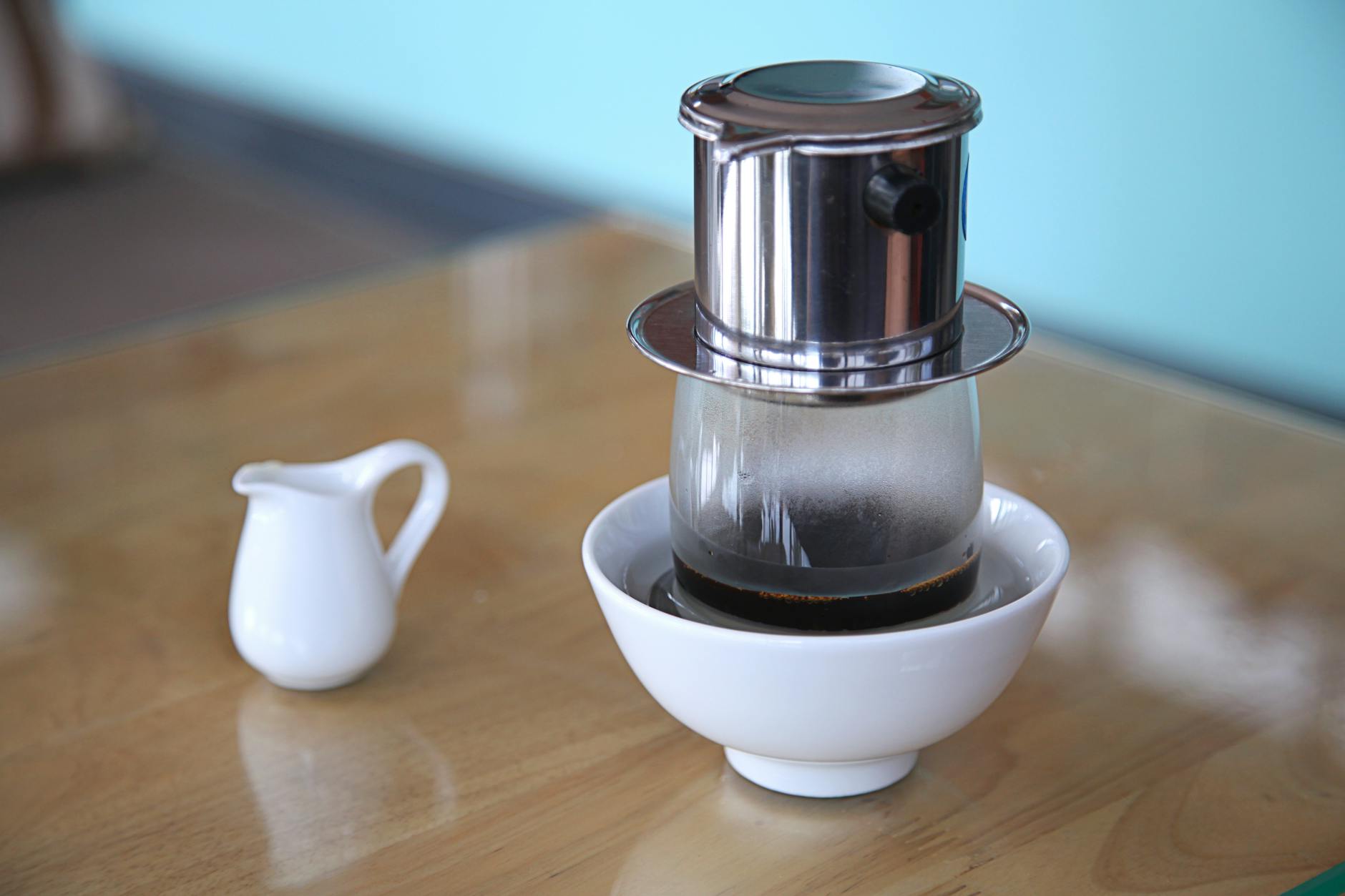 Hanoi Coffee Culture: Complete Guide to Vietnamese Coffee (2026) 2 Vietnamese phin drip coffee brewing into a glass in Hanoi