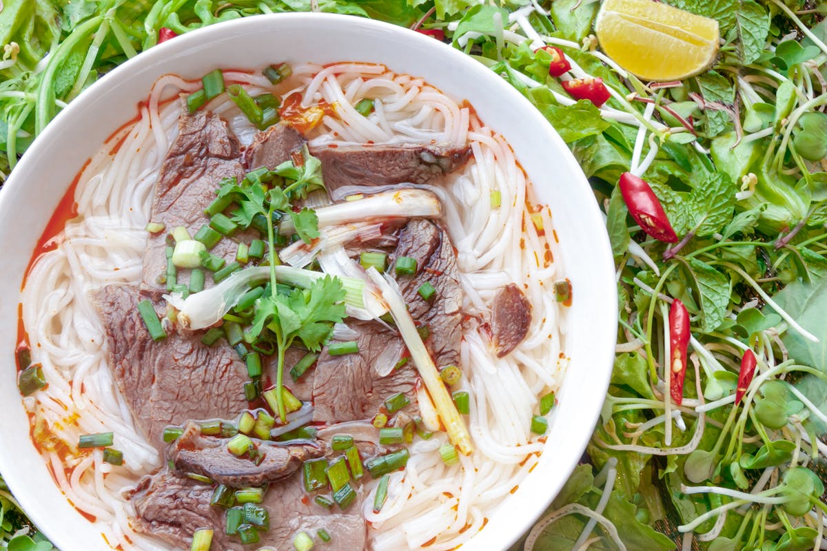 Bowl of traditional Vietnamese pho with beef herbs and rice noodles in Hanoi