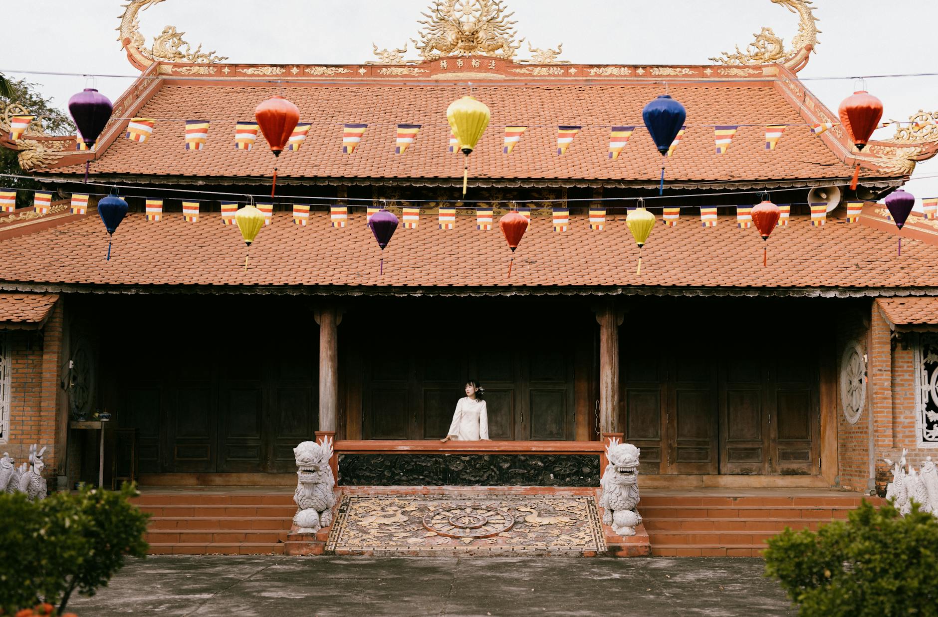 Traditional Asian building adorned with colorful lanterns and flags