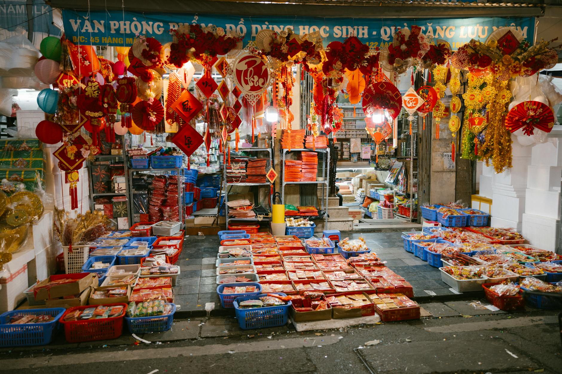 Vibrant display of traditional decorations and merchandise at an Asian night market stall