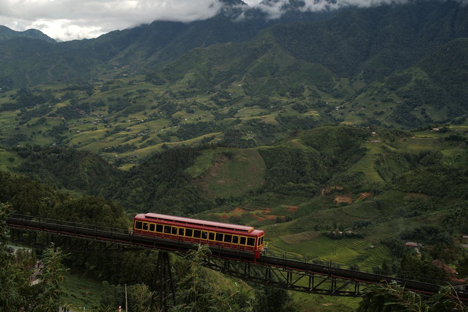 Train crossing bridge in lush Lao Cai mountains