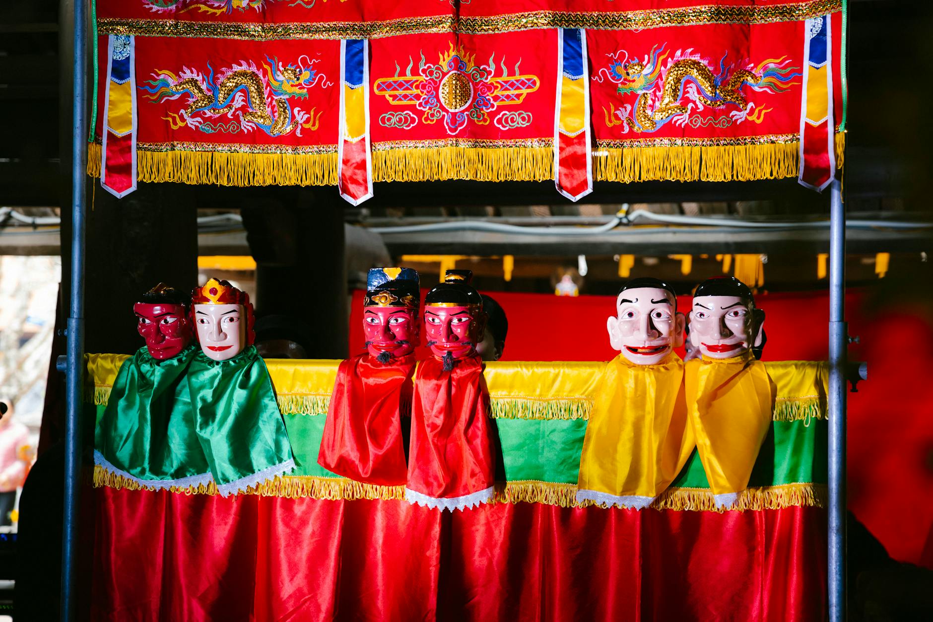 Colorful traditional puppet theater with vivid red, green, and yellow costumes