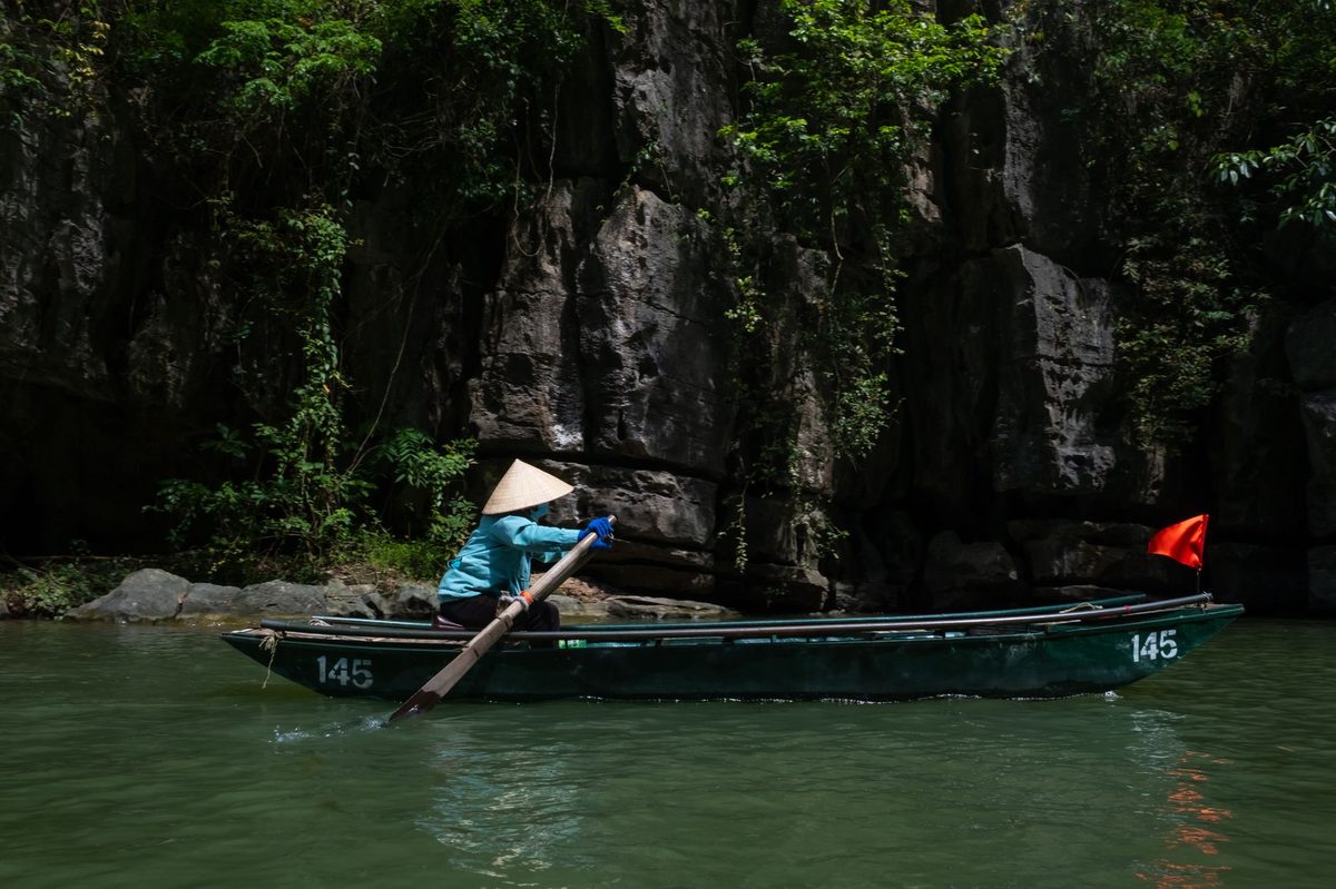 Boats winding through the limestone scenery of Ninh Binh, an easy day trip from Hanoi
